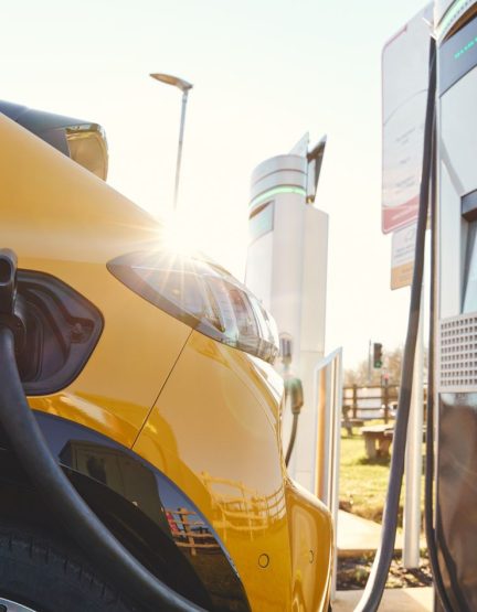 Plugged in electric car in at a EV charging station using a rapid-charger